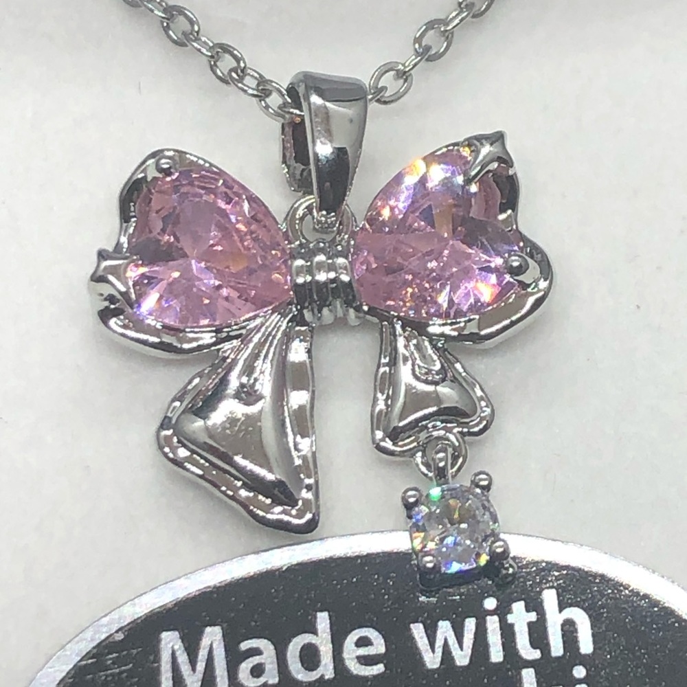 Beautiful Swarovski Crystals bow shaped. 16”S.Steel chain w/2” adjustment